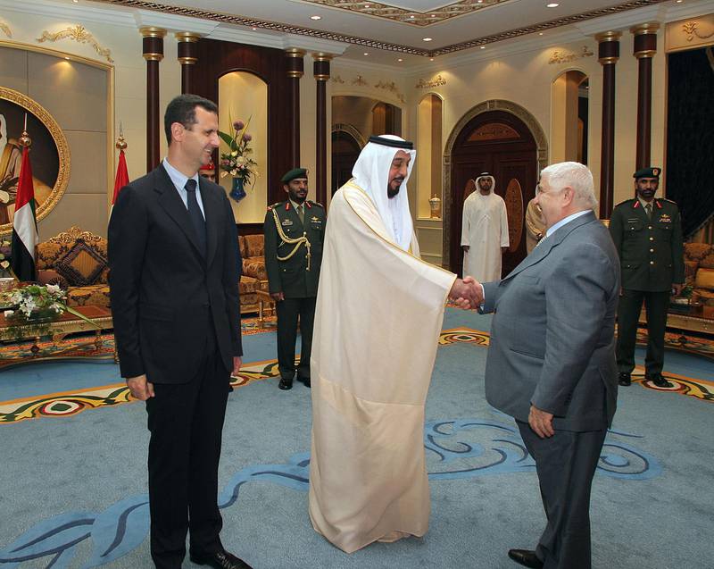 In a hand out picture released by the official Syrian Arab News Agency, visiting Syrian President Bashar al-Assad (L) stands by as Emirati President Sheikh Khalifa bin Zayed al-Nahayan (C) greets Syrian Foreign Minister Walid Muallem (R) in Abu Dhabi on June 1, 2008. Assad and and Sheikh Khalifa today voiced support for national accord in Lebanon, the UAE's WAM news agency reported. AFP PHOTO/HO/SANA  == RESTRICTED TO EDITORIAL USE == (Photo by SANA / AFP)