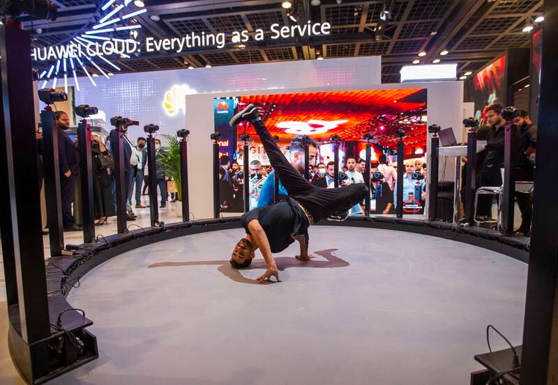A man dances at Huawei's stand.