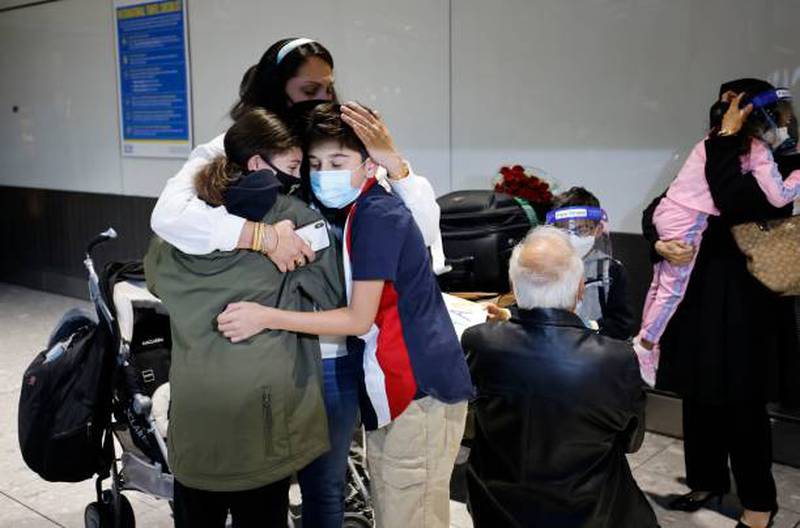 Families reunite as they arrive from the US at Heathrow.