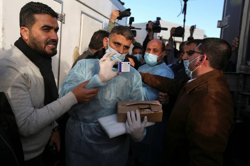A Palestinian health worker displays a box of Russia’s Sputnik V vaccine donated by the UAE. Reuters