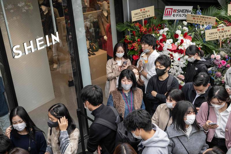 People queue outside the first permanent showroom of Chinese online fast fashion giant Shein on the opening day of the shop in Tokyo on November 13. Shein is the most Googled fashion brand in the world in 2022, according to a survey by money.co.uk. AFP