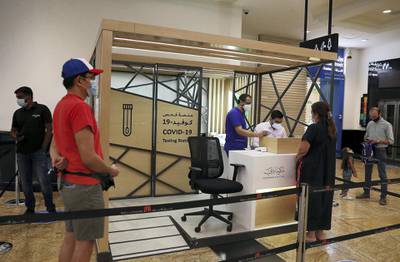 DUBAI, UNITED ARAB EMIRATES , October 14 – 2020 :- People taking their token for the COVID-19 nasal swab test at the COVID 19 testing station set up at Mall of the Emirates in Dubai. (Pawan Singh / The National) For News/Online. Story by Sarwat