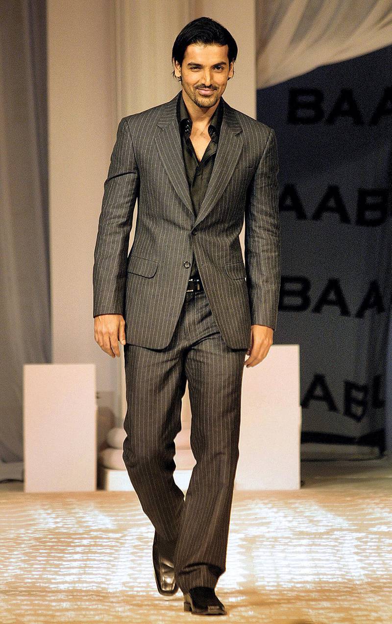 Indian film actor John Abraham walks the ramp at the music launch of the film "Babul" in Mumbai,  late 26 October 2006. Film production house B.R.Films celebrated its 50th year in the film industry and released its latest film's 'Babul' music CD with a fashion show in which the lead star cast took part.  AFP PHOTO/Sebastian D'SOUZA (Photo by SEBASTIAN D'SOUZA / AFP)
