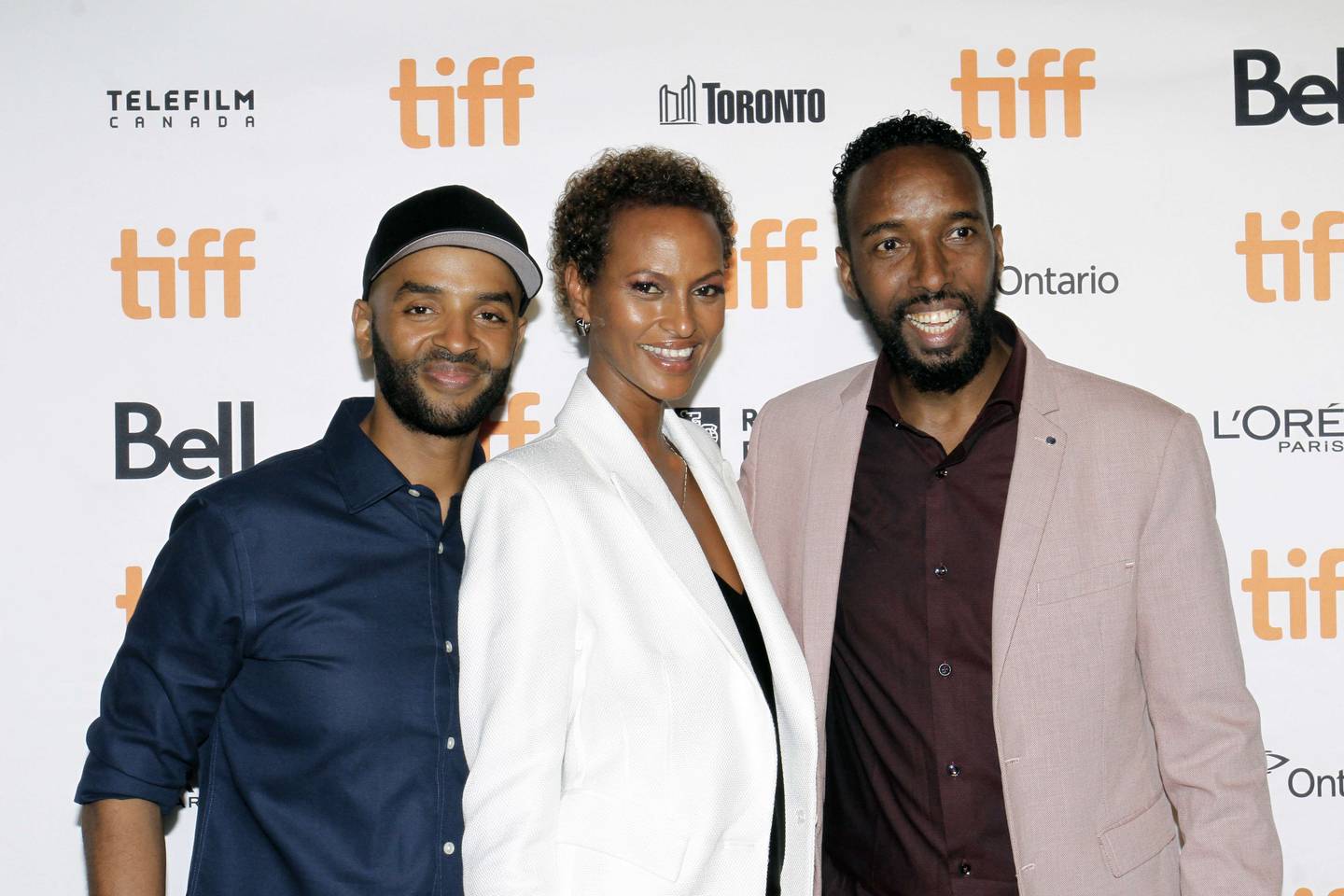 Khadar Ayderus Ahmed, left, Yasmin Warsame, centre, and Omar Abdi attend 'The Gravedigger's Wife' photocall during the 2021 Toronto International Film Festival. AFP