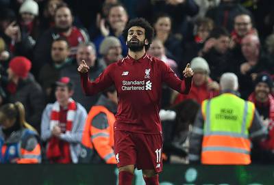 Liverpool's Egyptian midfielder Mohamed Salah celebrates scoring the opening goal during the UEFA Champions League group C football match between Liverpool and Napoli at Anfield stadium in Liverpool, north west England on December 11, 2018.  / AFP / Paul ELLIS
