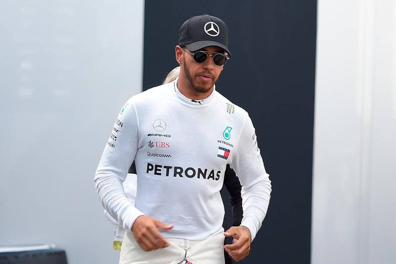 Mercedes' British driver Lewis Hamilton walks in the paddock of the Circuit de Catalunya on March 9, 2018 in Montmelo on the outskirts of Barcelona during the tests for the Formula One Grand Prix season. / AFP PHOTO / LLUIS GENE
