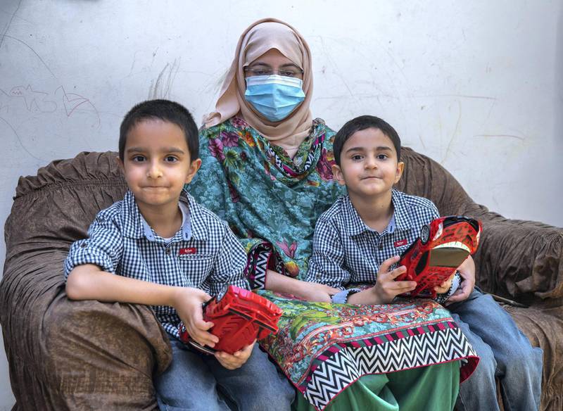 Abu Dhabi, United Arab Emirates, December, 1, 2020.  STORY BRIEF: Widow of a fallenfrontline worker, Dr. Muhammad Usman Khan. (L-R)Alia Usman with her children, Mohanad, six and Akhdan, five at their home in Mohamed Bin Zayed City.  Victor Besa/The NationalSection:  National NewsReporter:  Sarwat Nasir