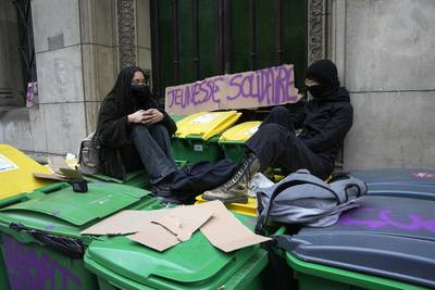 Striking pupils sit outside their high school in Paris. AP