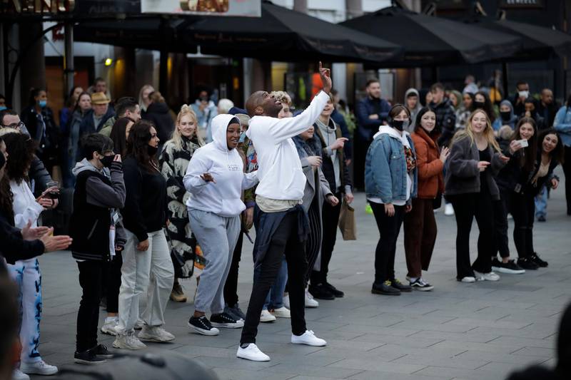 People join in a dance led by a street performer in Leicester Square, London. AP Photo