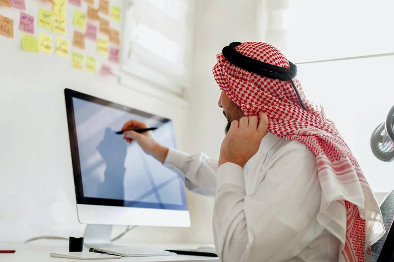 Middle Eastern businessman working in office as designer on computer