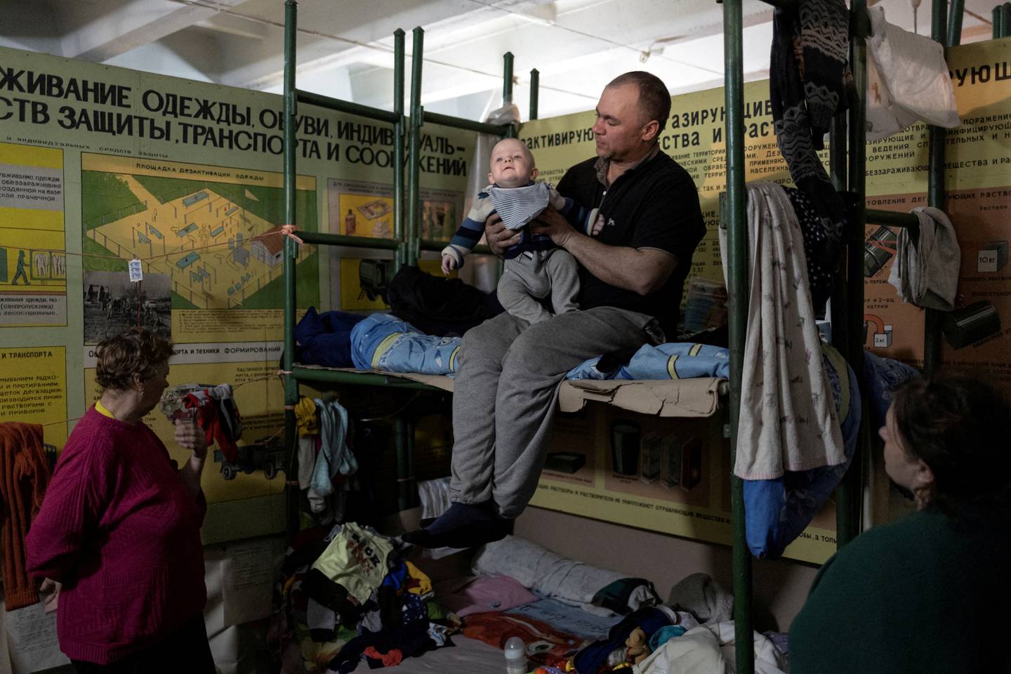 A man holds his baby inside Azot chemical plant's bomb shelter in Sievierodonetsk, Luhansk region, Ukraine. Reuters