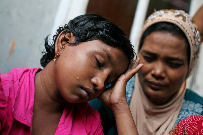 Senwara Begum  cries at a temporary shelter in Medan, North Sumatra, Indonesia after making a phone call to her family in Myanmar. AP Photo/Binsar Bakkara