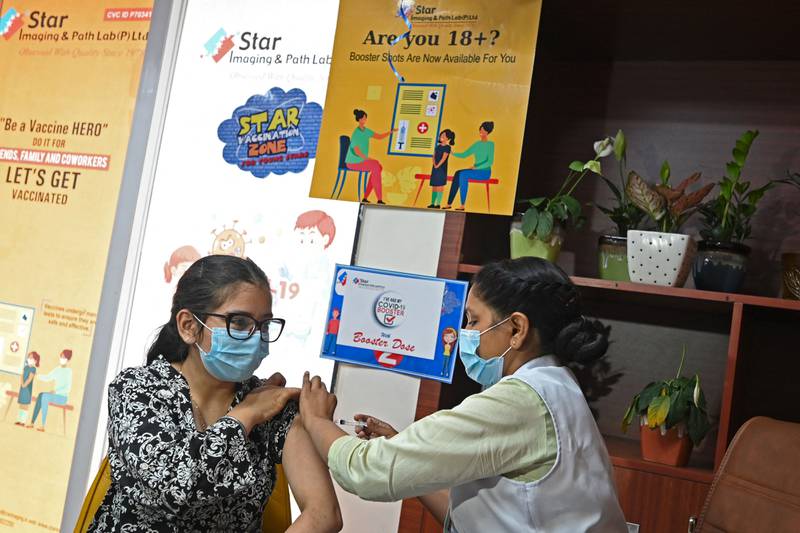 A health worker inoculates a girl with a dose of the Covaxin vaccine against the Covid-19 coronavirus at a vaccination centre in New Delhi on April 10, 2022, after government announced the paid precaution dose against Covid-19 coronavirus to be available for everyone above 18 years of age at private vaccination centres. AFP