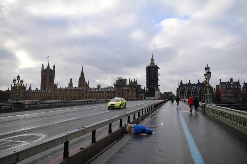 Pedestrians walk on a near-deserted Westminster Bridge in central London. AFP