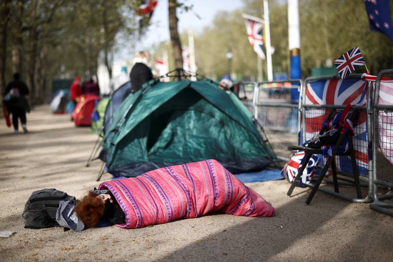 A royal fan sleeps at The Mall outside Buckingham Palace as the countdown to the coronation continues. Reuters