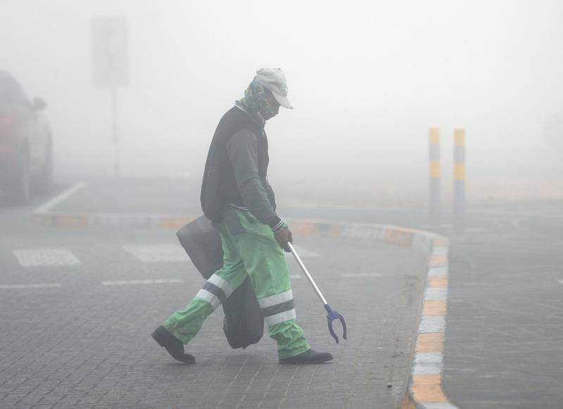 Abu Dhabi, United Arab Emirates, December 30, 2019.  A municipality worker cleaning up the streets on a foggy morning at Khalifa City, Abu Dhabi.Victor Besa / The NationalSection:   NA Reporter: