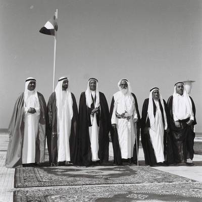 History Project 2010, "The First Day". Sheikh Zayed and UAE rulers at Union House in Dubai. December 2, 1971. Sheikhs pictured from left-right :Sharjah - Sheikh Khalid Al Qasami, Abu Dhabi - Sheikh Zayed Al Nayhan (born 1981), Dubai - Sheikh Rashid Al Maktoum (born 1912) , Ajman - Sheikh Rashed Al Nuami (born 1902) Fujeirah - Sheikh Mohammed Al Sharqi, UAQ - Sheikh Ahmed Al' Mu'alla. 