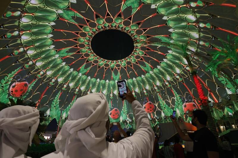 Visitors watch light projections at Expo 2020.