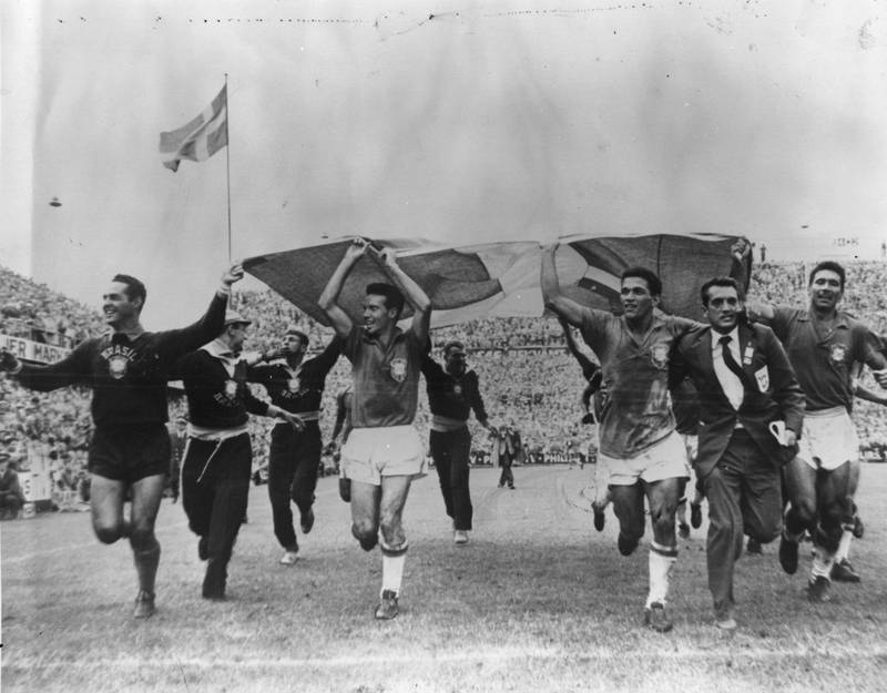 1958 World Cup, Sweden. The Brazil team celebrate their first championship. In a magnanimous gesture, the players ran around the stadium waving the Swedish flag to acknowledge the support they received from the crowd after winning the final against Sweden in Stockholm. Brazil won the match 5-2. Getty Images
