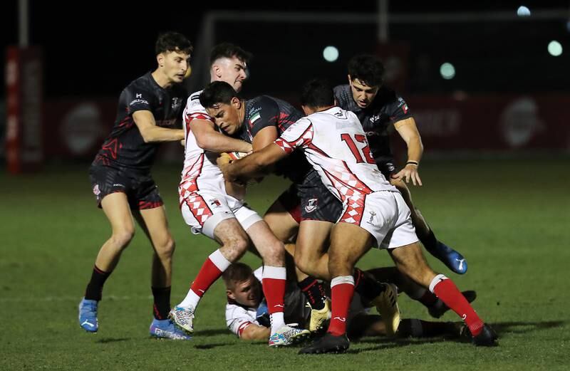 Abu Dhabi Harlequins attempt to tackle a Dubai Exiles player.