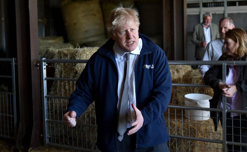 Britain's Prime Minister Boris Johnson visits Moor Farm in Stoney Middleton, England, Friday, April 23, 2021, as part of a Conservative party local election visit. (AP Photo/Rui Vieira, Pool)