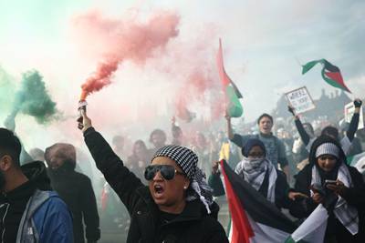 Smoke canisters were set off on Westminster Bridge as thousands of pro-Palestinian protesters marched in London on Saturday. AFP