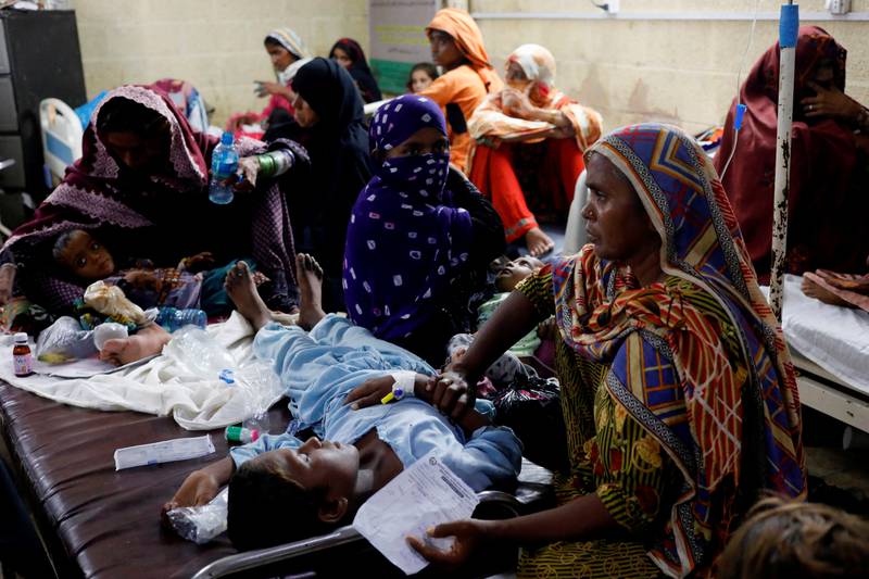 Women wait with their sick children at the medical institute in Sehwan. Reuters