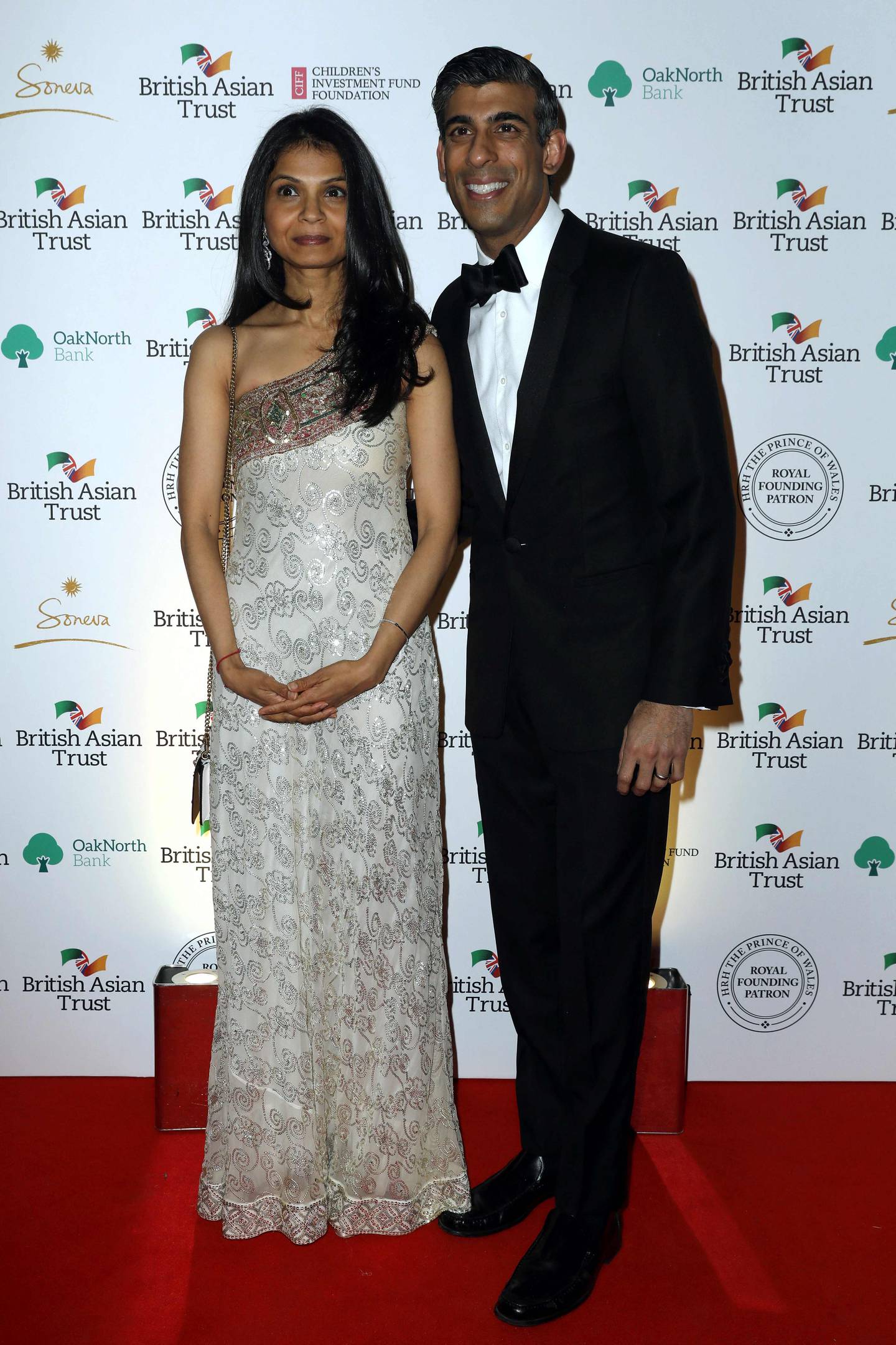 In this photo taken on February 9, 2022, Britain's Chancellor of the Exchequer Rishi Sunak poses with his wife, Akshata Murty, during a reception to celebrate the British Asian Trust at The British Museum in London. AFP