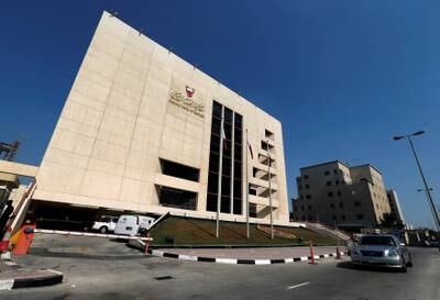 FILE PHOTO: A car passes in front of the Central Bank of Bahrain in Manama October 27, 2013.   REUTERS/Hamad I Mohammed/File photo