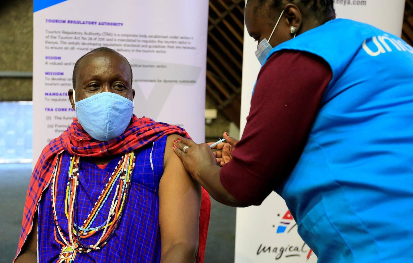 FILE PHOTO: Kenyan tour guide, Daniel Ole Kissipan, receives the AstraZeneca/Oxford vaccine against the coronavirus disease (COVID-19) under the COVAX scheme, in Nairobi, Kenya, April 27, 2021. REUTERS/Monicah Mwangi/File Photo