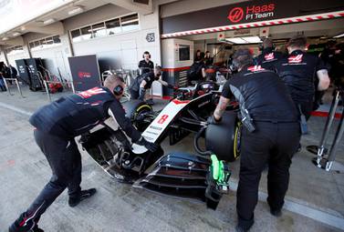 Haas' Romain Grosjean is pushed into the pits during the pre-season testing in Barcelona. Reuters