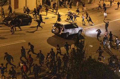 Migrants clash with Moroccan riot police in Fnideq. Spain has expelled thousands who crossed into its enclave of Ceuta after Morocco relaxed controls on the border. AFP