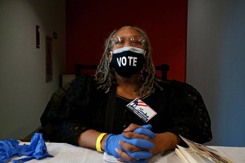 A poll worker poses for a picture in the Entertainment and Sports Arena in Southeast Washington, DC. EPA