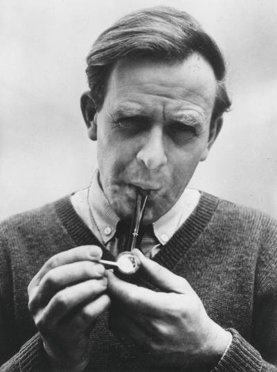 1980:  John Le Carre, (pseudonym of David John Moore Cornwell) (1931 - ) the English novelist, lighting his pipe.  (Photo by Evening Standard/Getty Images)