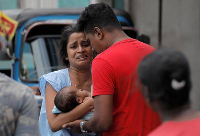 A woman and her newborn baby leave their house as the military try to defuse a suspected bomb in a van before it exploded. Reuters