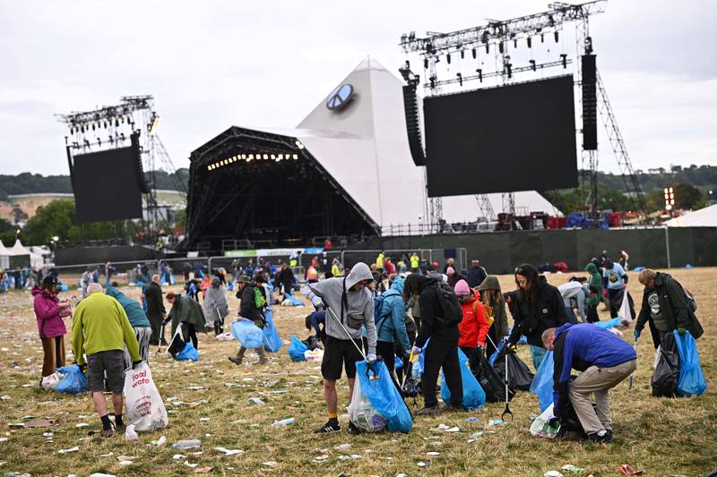 Volunteers clean up by the Pyramid Stage at Worthy Farm in Somerset, after the Glastonbury Festival in Britain. Reuters