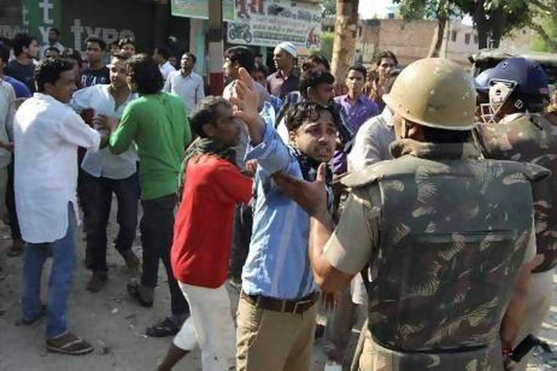 People argue with Indian policemen during curfew hours following riots and clashes between Hindus and Muslims in Muzaffarnagar, in the Indian state of Uttar Pradesh.