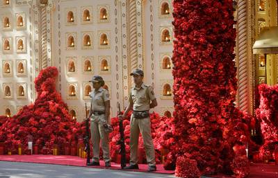 The venue is decked out in flowers and lights, with plenty of security personnel. AP Photo