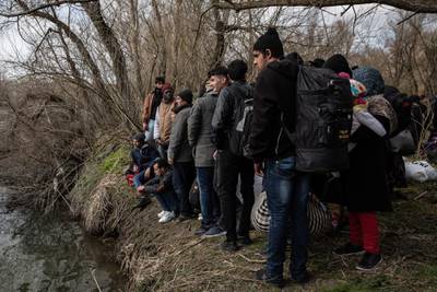 Refugees and migrants from various countries wait on the shoreline for a boat to cross the Evros River in an attempt to reach Greece from Turkey in Edirne, Turkey. Getty Images
