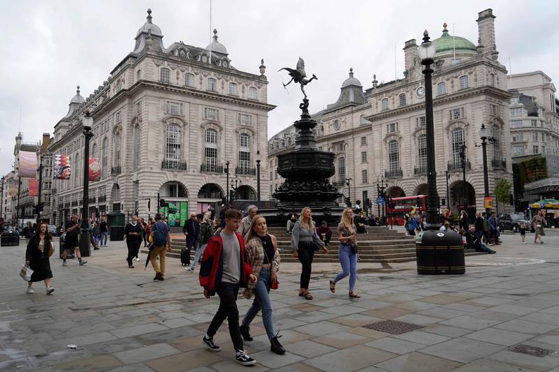 Pedestrians go about their business in Piccadilly Circus, central London. AFP