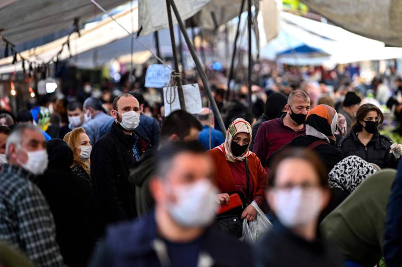 People walk through a market in Bayrampasa, Istanbul, Turkey. AFP