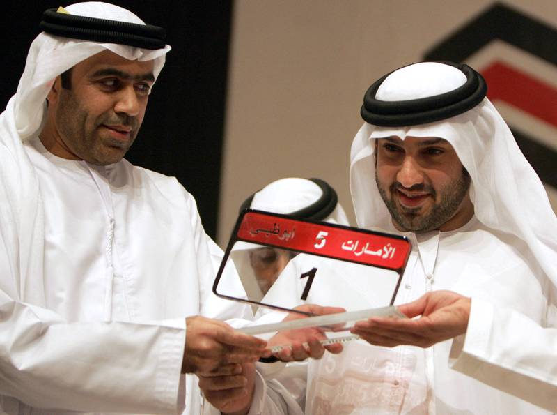 Saeed Khoury, right, poses with the most expensive car number plate after he won it in an auction in Abu Dhabi on February 16, 2008. AFP