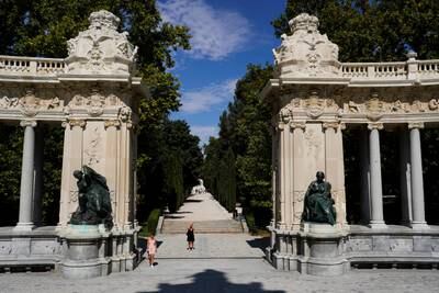 A woman takes pictures at El Retiro Park on the day that Unesco added Madrid's historic Paseo del Prado boulevard and Retiro Park to its list of World Heritage Sites
