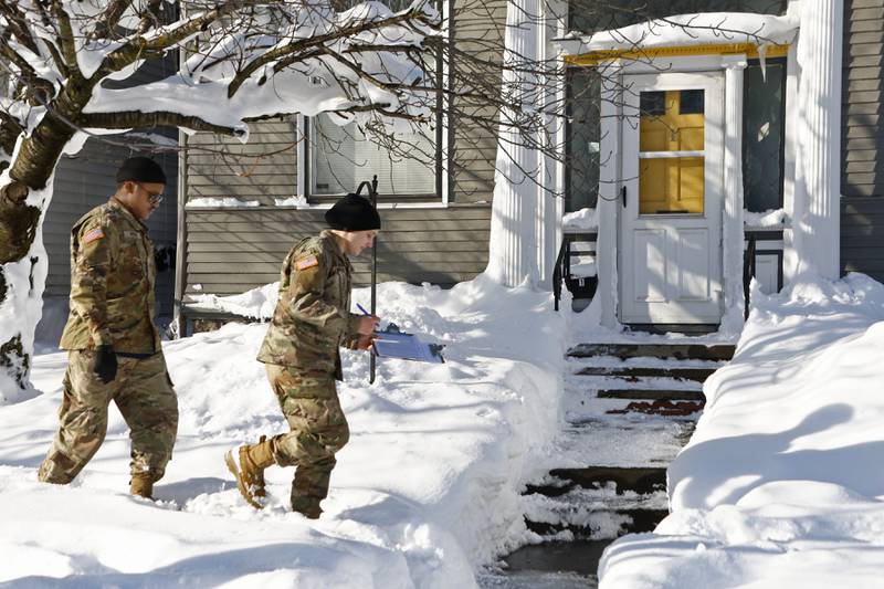 National Guard members check on residents on Wednesday in Buffalo. AP