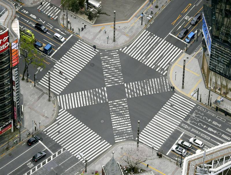 An aerial view shows less than usual passersby seen at a pedestrian crossing at Ginza shopping and amusement district after Tokyo Governor Yuriko Koike urged Tokyo residents to stay indoors in a bid to keep the coronavirus disease (COVID-19) from spreading, in Tokyo, Japan. REUTERS