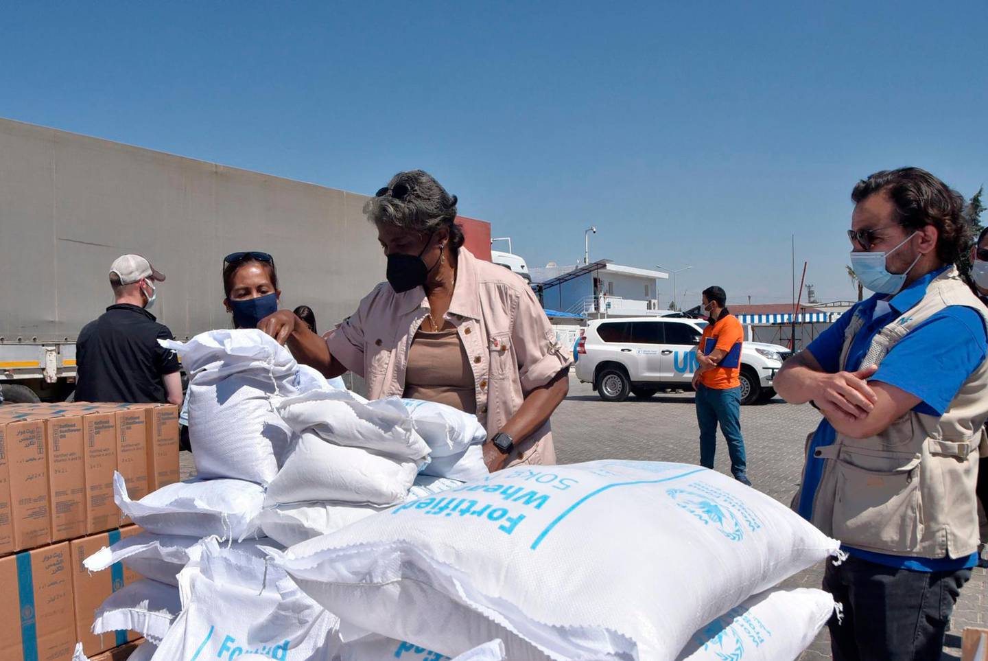FILE - In this June 3, 2021 handout file photo provided by the US Embassy in Turkey, Linda Thomas-Greenfield, U.S. Ambassador to the United Nations, examines aid materials at the Bab al-Hawa border crossing between Turkey and Syria. Millions of Syrians risk losing access to lifesaving aid, including food and COVID-19 vaccines if Russia gets its way at the Security Council by blocking the use of the last remaining cross-border aid corridor into northwestern Syria, an international rights group said Thursday, June 10. (US Embassy in Turkey via AP)