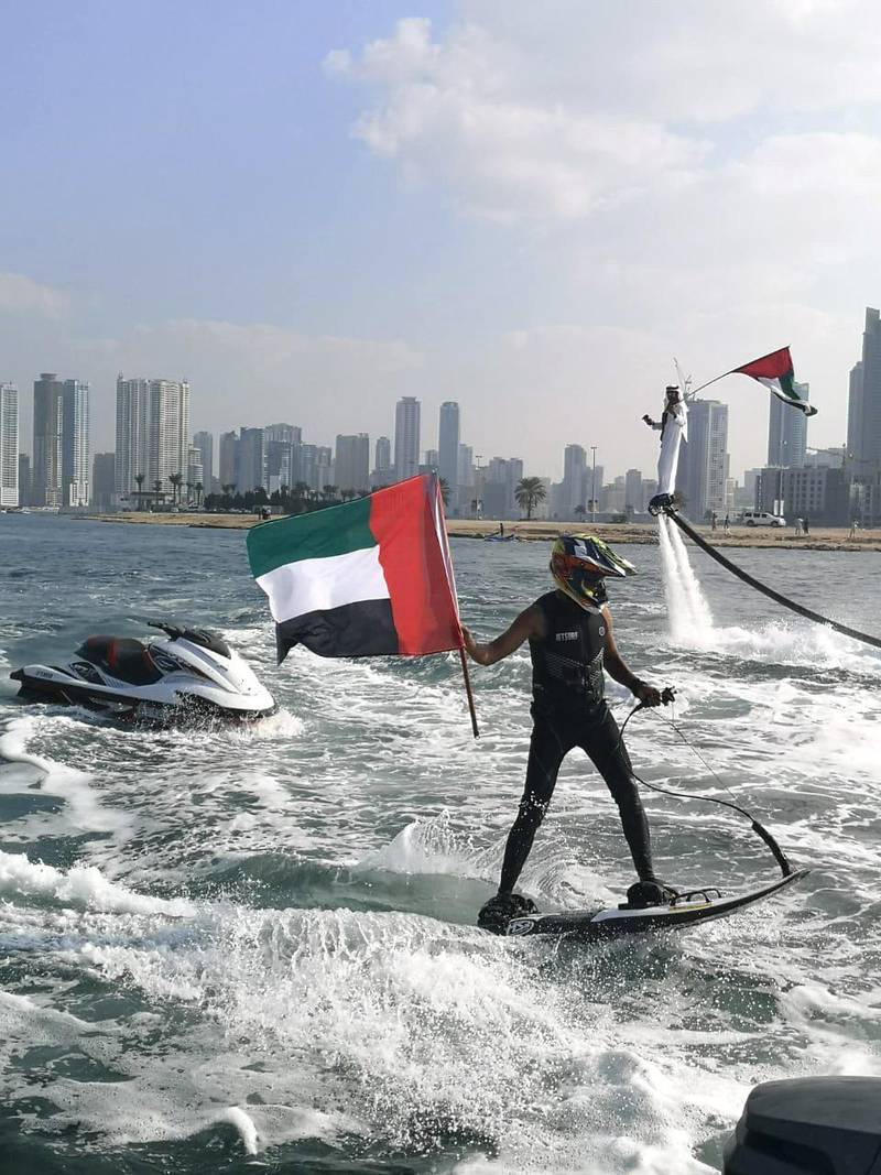Men on jetskis, flyboards and waterskiing take part in National Day celebrations at Sharjah Maritime Museum. Salam Al Amir / The National