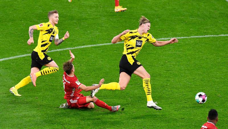 Bayern Munich's Joshua Kimmich challenges Borussia Dortmund attacker Erling Haaland druring Der Klassiker on November 7, 2020. Bayern won the Bundesliga clash 3-2. EPA