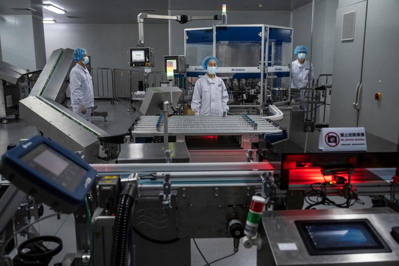 Workers in the packaging area of Sinopharm's vaccine production centre. Getty
