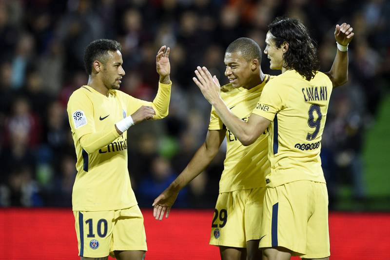 (From L) Paris Saint-Germain's Brazilian forward Neymar, Paris Saint-Germain's French forward Kylian Mbappe and Paris Saint-Germain's Uruguayan forward Edinson Cavani celebrate a goal during the French L1 football match between Metz (FCM) and Paris Saint-Germain (PSG) on September 8, 2017 at the Saint-Symphorien stadium in Longeville-les-Metz, northeastern France.  / AFP PHOTO / Jean-Christophe VERHAEGEN